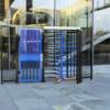 Full height turnstile and full height gate in custom 2-tone blue and black colorway installed in front of office