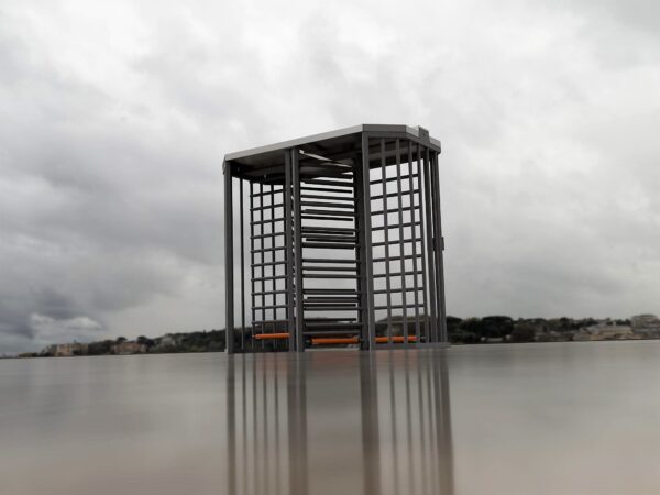 full height tandem turnstile installed outdoors with a climb over canopy at the top