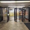 1 tandem full height turnstile and 2 full height ADA gates in a hallway at JFK international airport