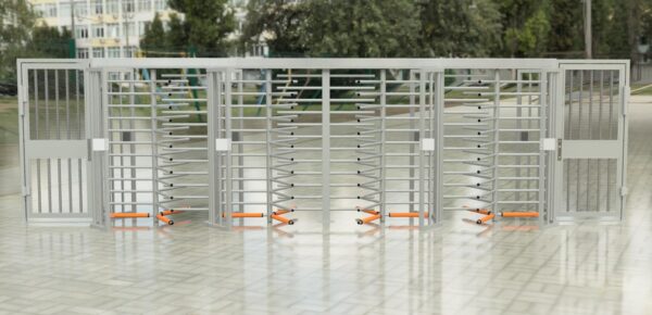 full height turnstiles and security gates installed in a line in a building