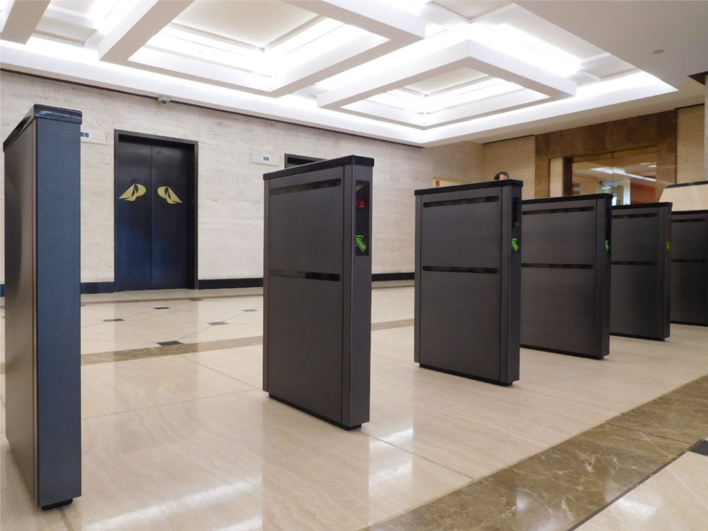 barrier-free optical turnstiles in a row in an upscale office lobby