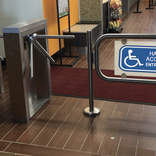 Handicap accessable security gate access sytem. Hayward Turnstiles ADA swing gate entrance for lobby, library, office