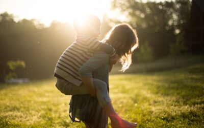 little boy piggybacking behind his older sister