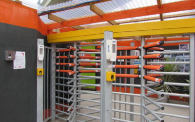 full height turnstile with orange padded safety sleeves at head and arm level