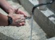 person washing his hands with a black watch on