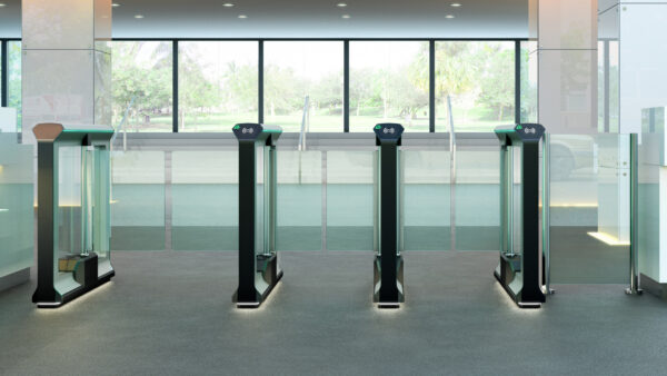 row of optical turnstile swinging glass barrier lanes in an office building