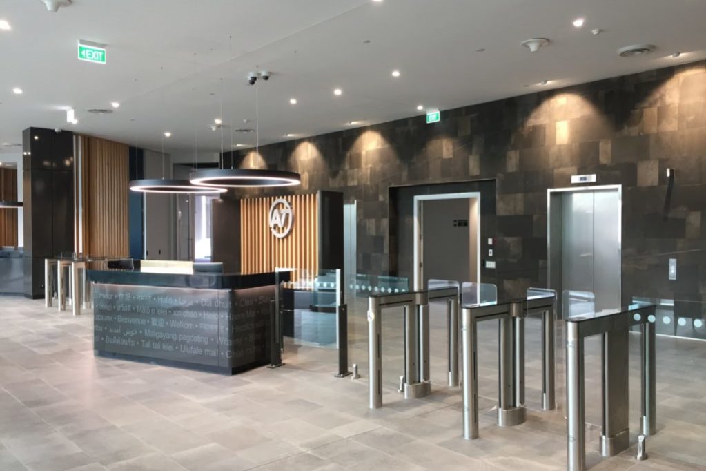 optical swinging glass turnstiles in an upscale office lobby access control