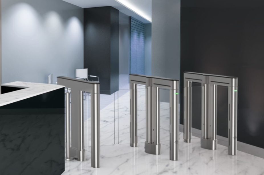 SL2000 optical swinging glass turnstile installed in an office lobby next to a black desk with a white stone top