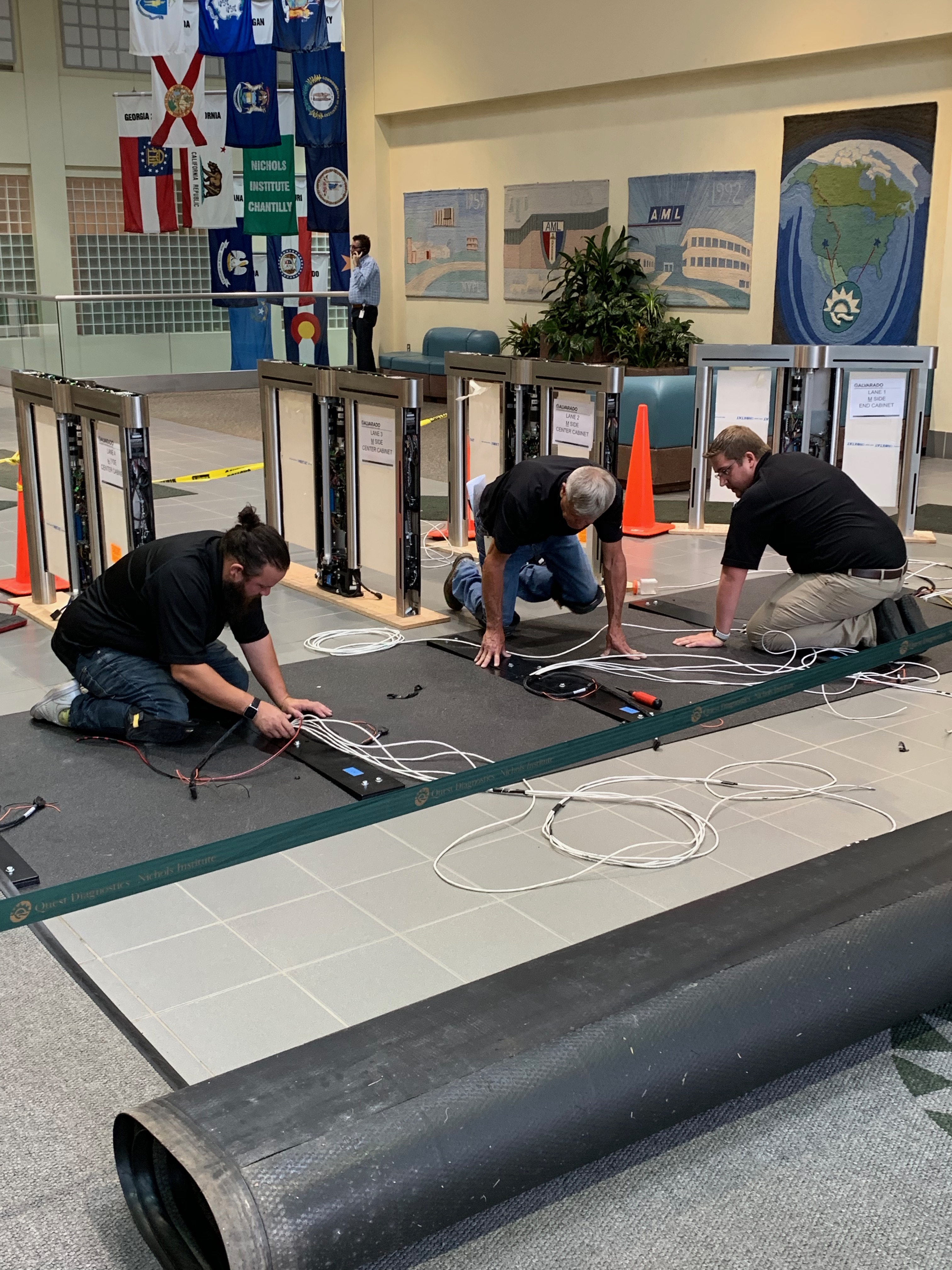 Avant-Garde Turnstiles team installing optical turnstiles