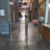 An MR200 ADA turnstile installed at the entrance of Glenwood YMCA, with large windows and a well-lit interior visible in the background.