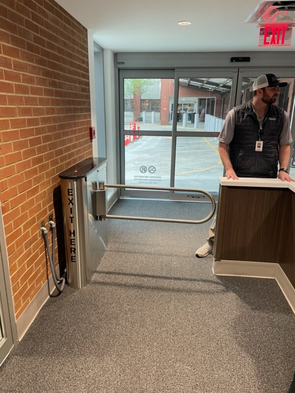 An MR200 ADA turnstile installed next to a reception desk.