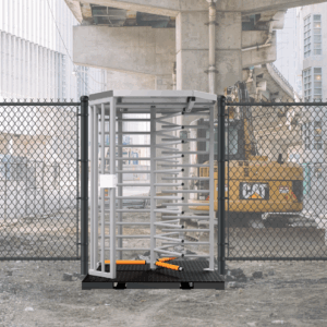 HT431P full-height turnstile installed at a construction site, with fencing and construction equipment in the background.